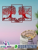 لوحة فنية لوجهين بفروع الشجر