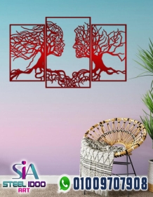 لوحة فنية لوجهين بفروع الشجر